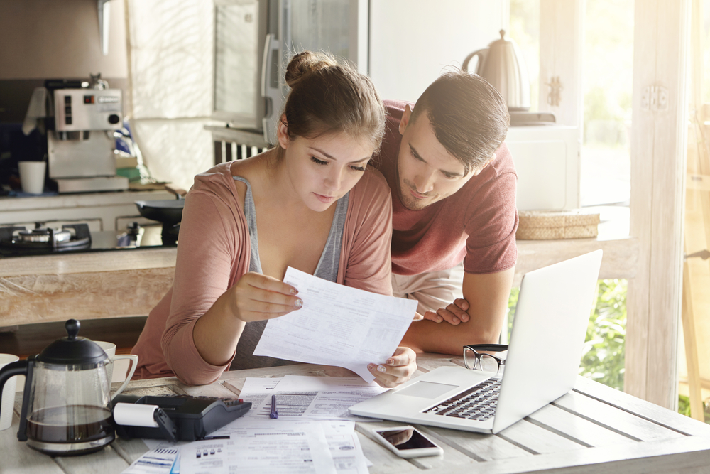 Couple checking real estate financial statement