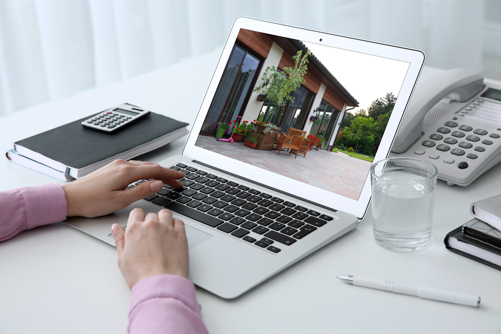 a person looking on a house on the laptop