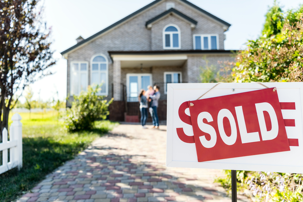 a house with a sold post on the front