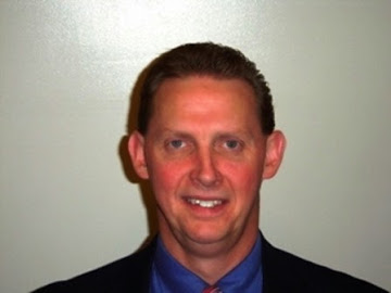 Jim West, real estate agent in Marysville, Ohio, wearing a suit and tie in a professional headshot.