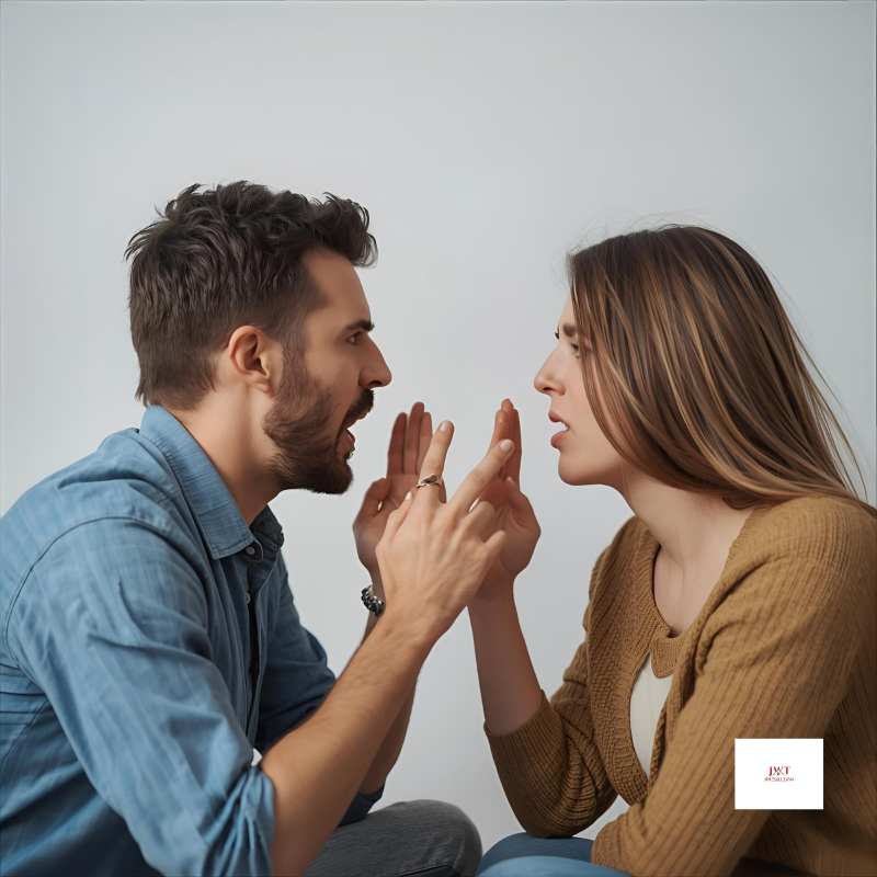 A man and woman facing each other in a heated argument, both visibly upset, gesturing with their hands during a tense moment—symbolizing the emotional conflict often present in divorce situation