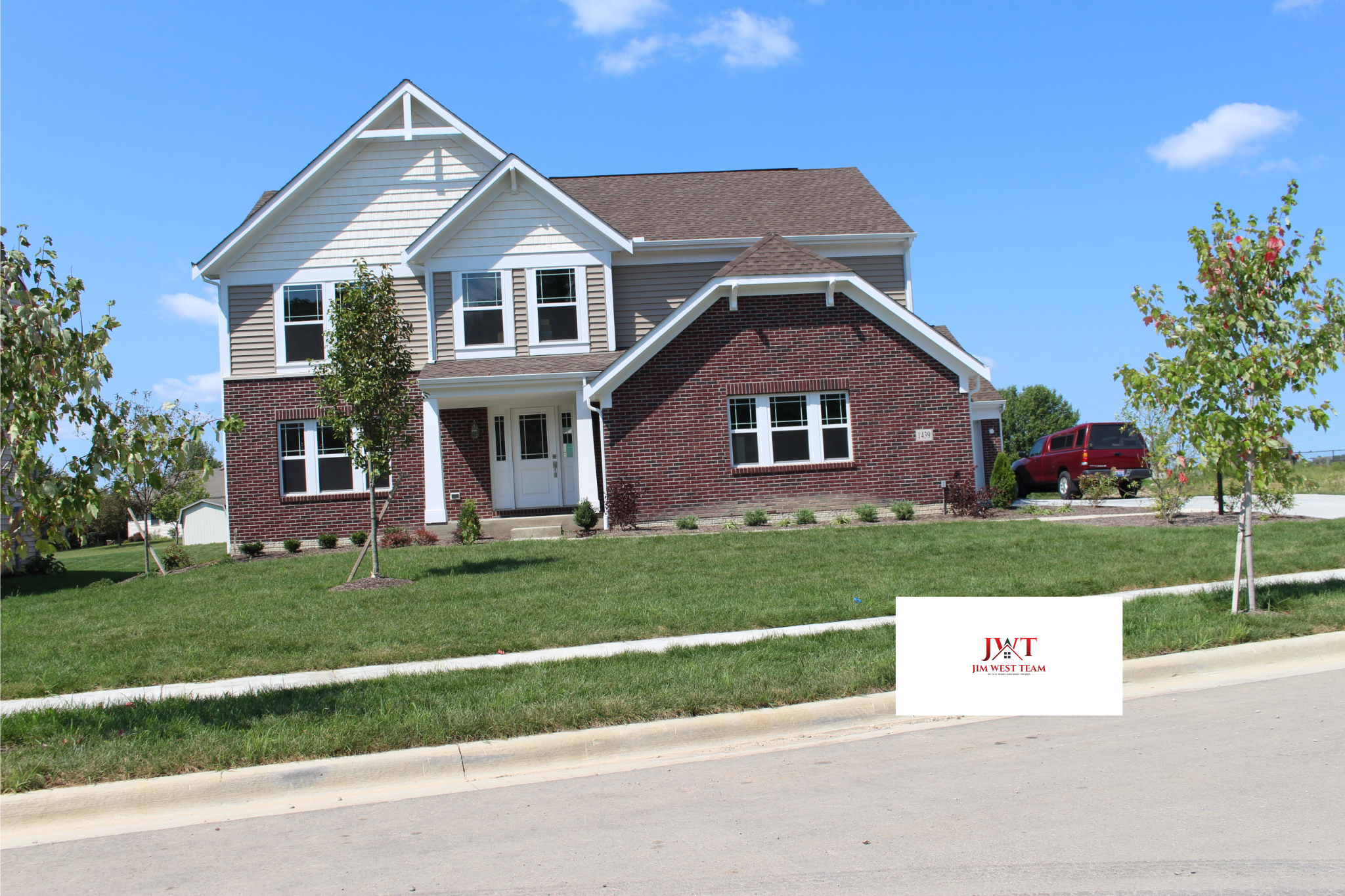 Two-story brick and siding home in Adena Pointe, Marysville, Ohio, with attached garage, landscaped yard, and driveway