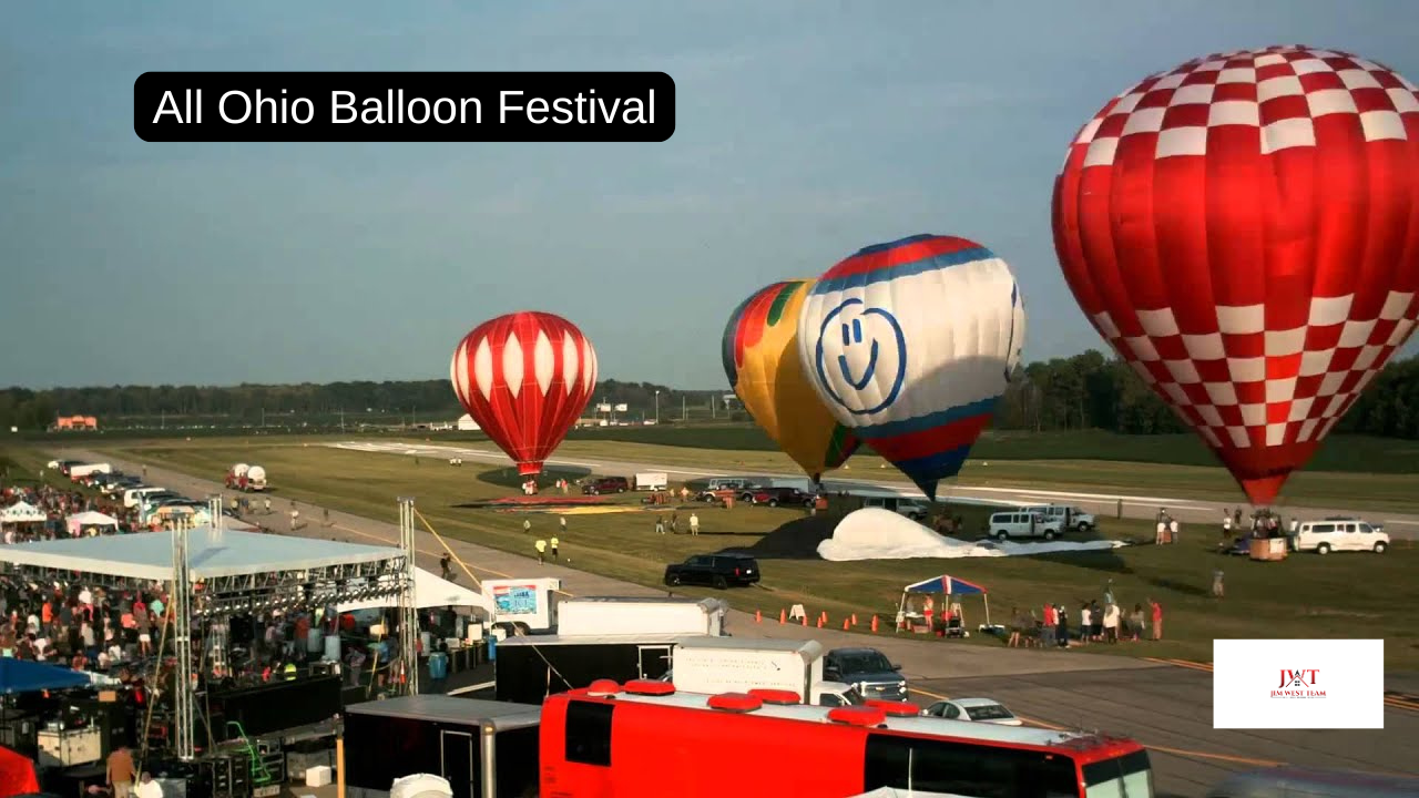 Hot air balloons launching at the All Ohio Balloon Festival in Marysville, Ohio, with crowds, tents, and colorful balloons at Union County Airport