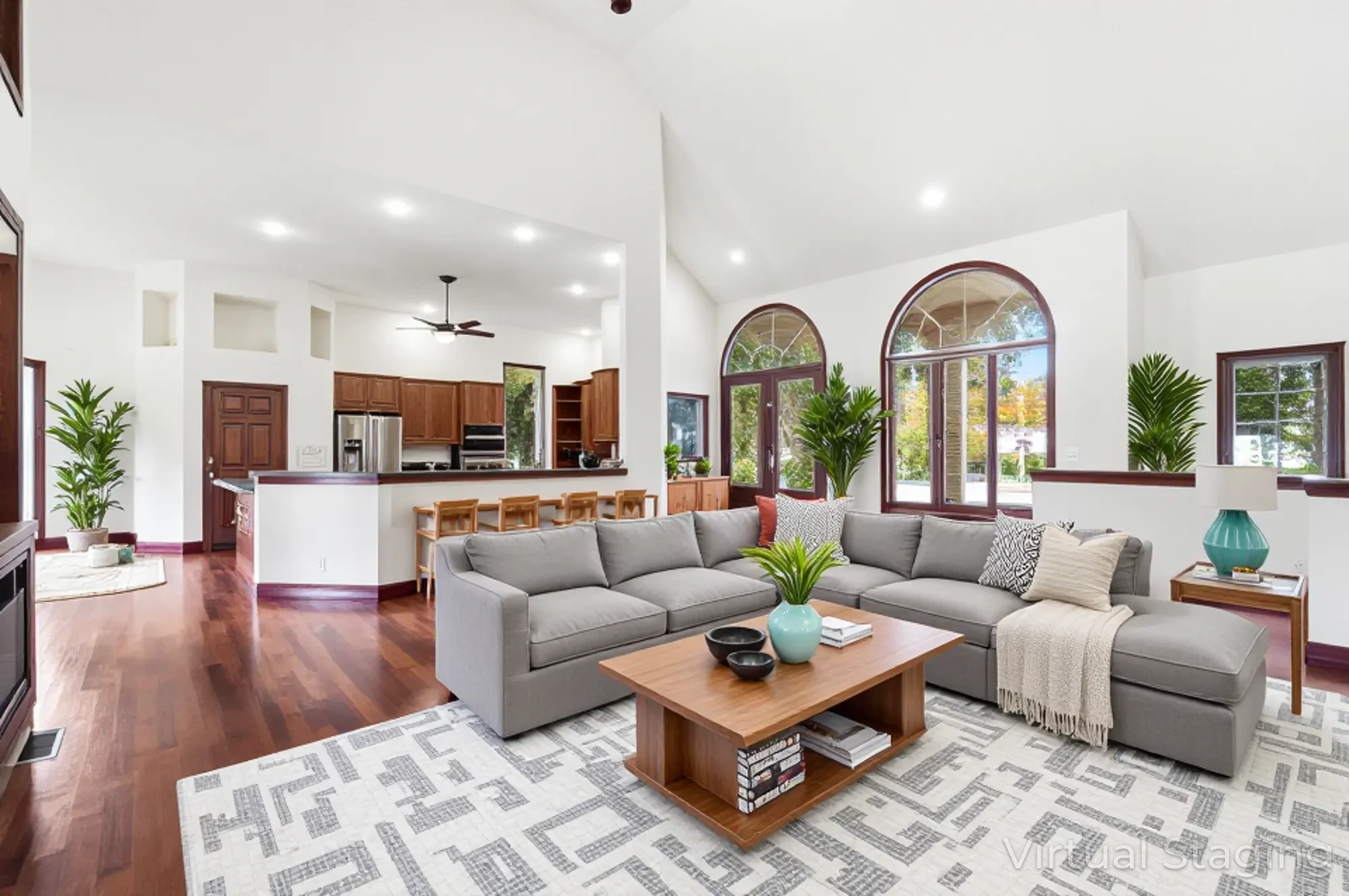 Open concept floor plan showing kitchen flowing into living room with soaring ceilings and arched windows at 250 Emmaus Rd Marysville