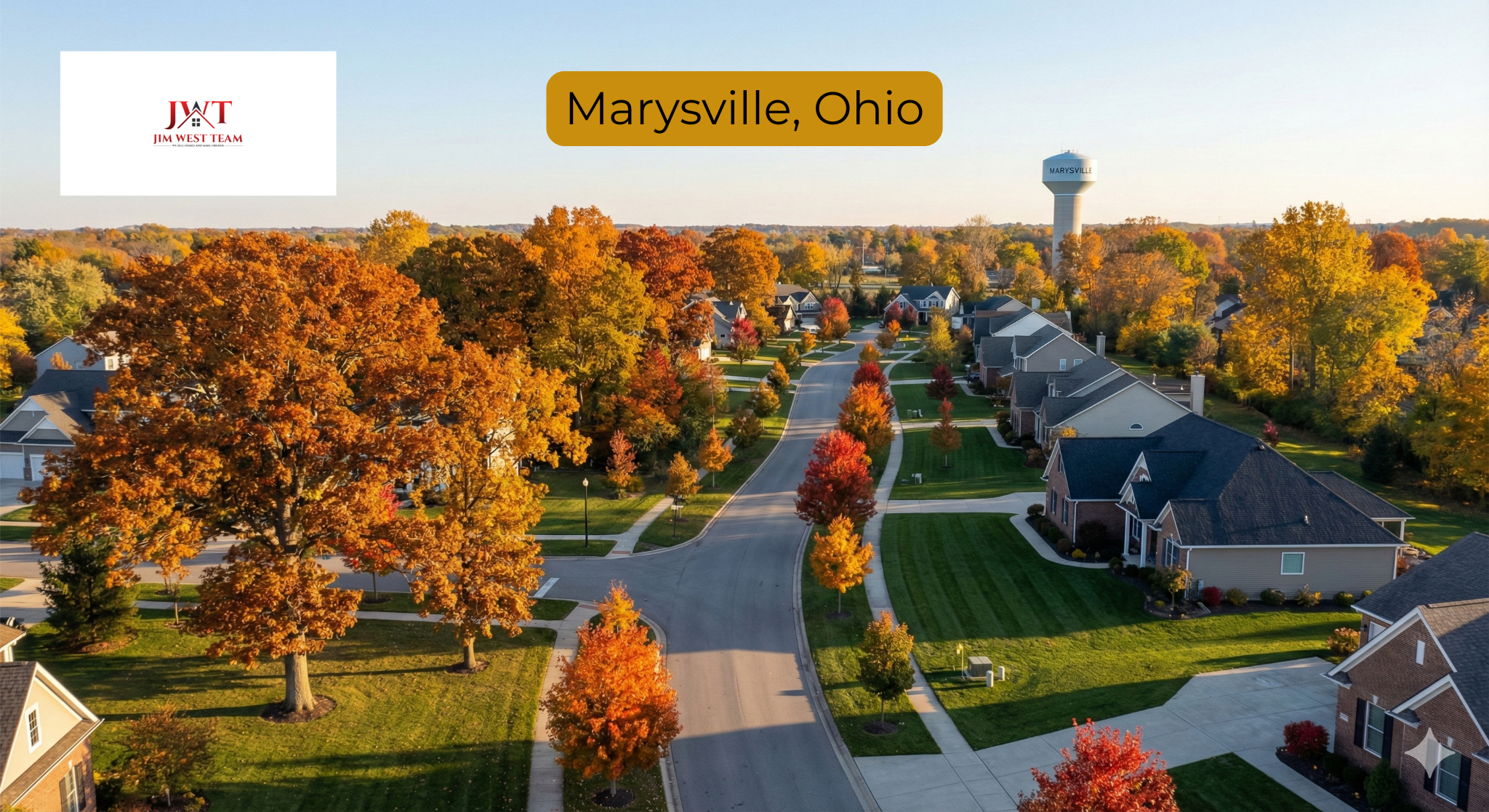 Aerial view of Marysville Ohio neighborhood in autumn showing tree-lined streets with fall foliage and single-family homes with Marysville water tower