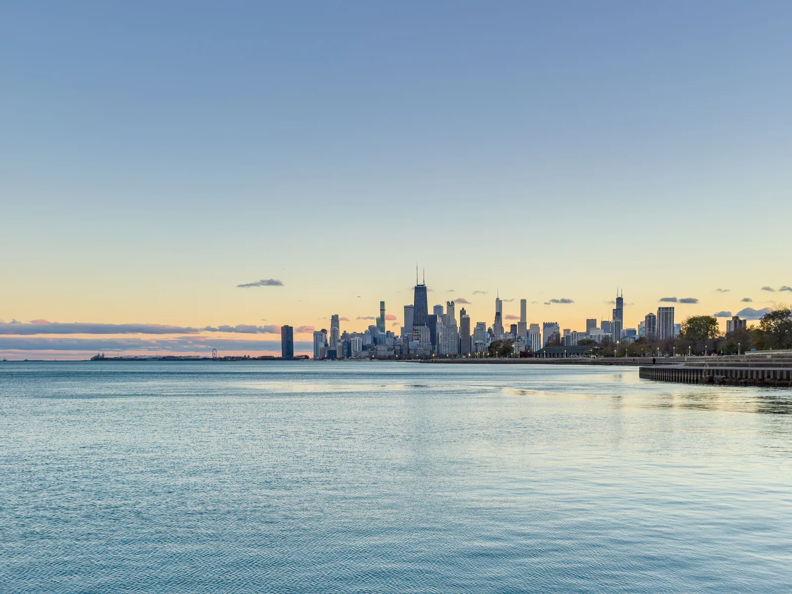 Downtown Chicago skyline at dusk across Lake Michigan, seen from the North Side lakefront