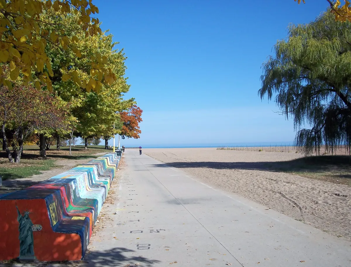 Lakefront path, painted seawall and sand at Loyola Park beach in Rogers Park, Chicago