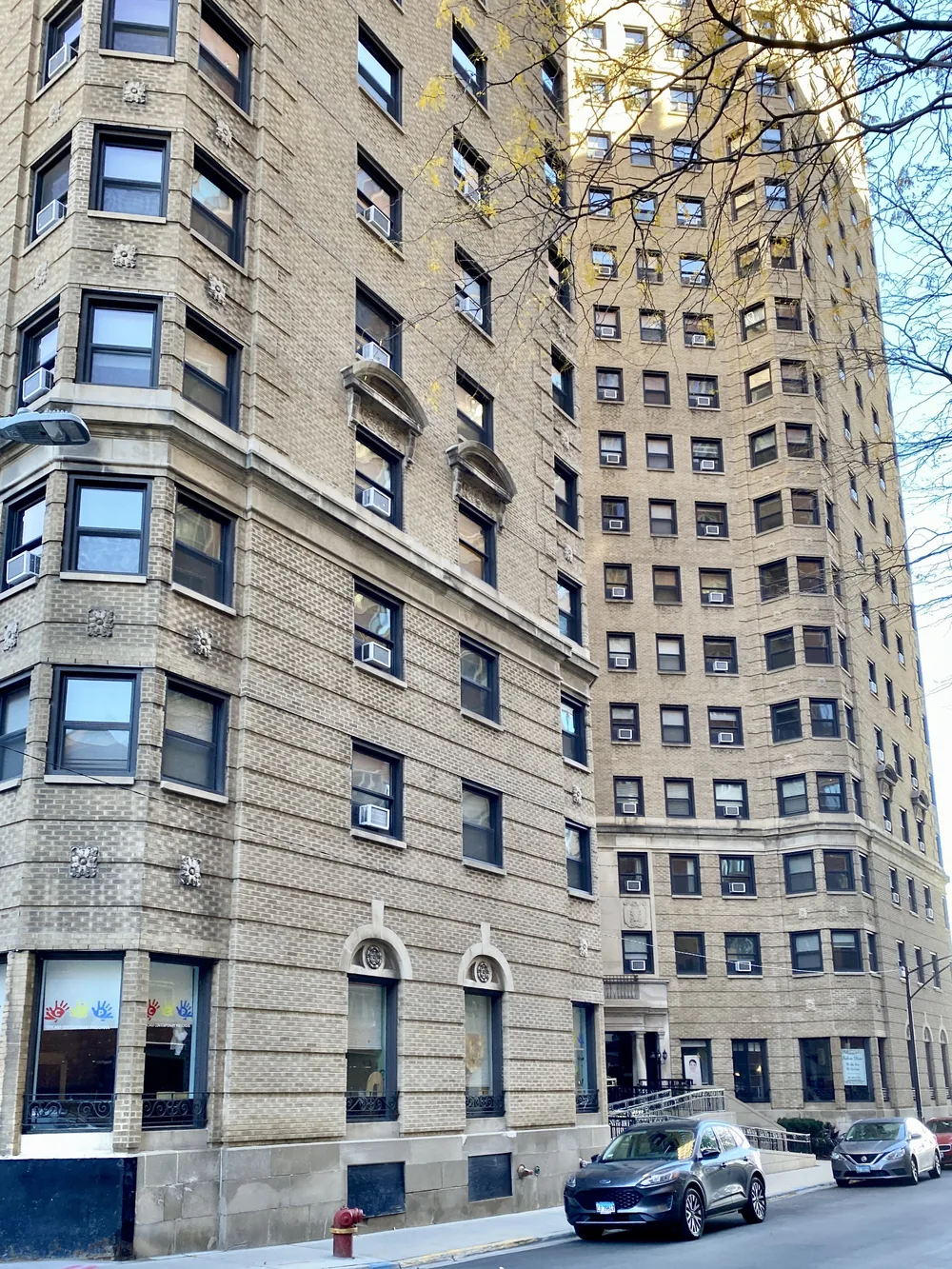 Buff brick vintage high-rise apartment building with stone trim on Lake Shore Drive in the Gold Coast, Chicago
