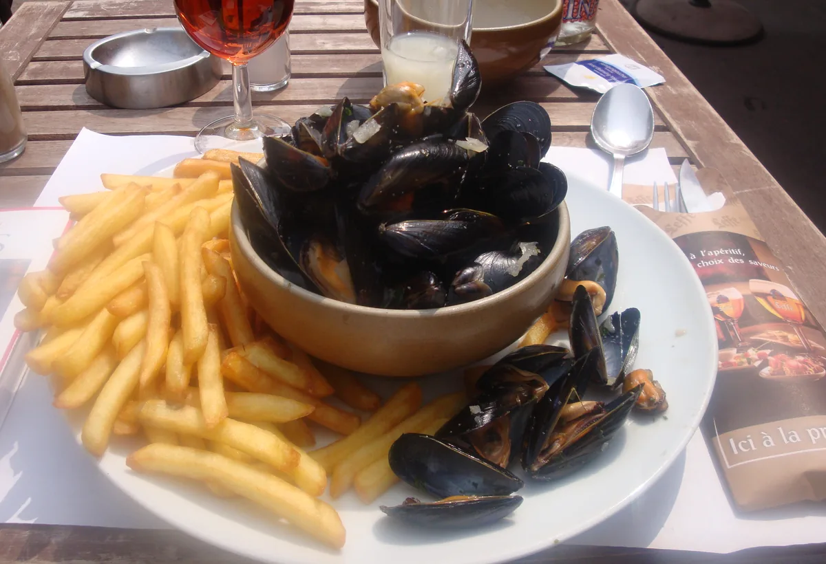 Bowl of steamed mussels with a plate of frites, the Belgian dish Hopleaf in Andersonville is known for