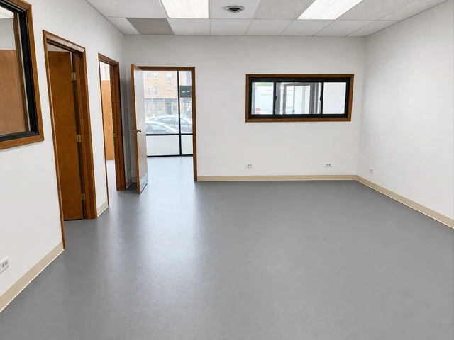 Freshly painted room with an interior window and several doors leading to separate offices at 6602 N Clark St