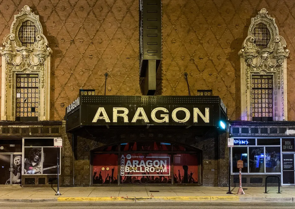 Lit marquee and ornate facade of the Aragon Ballroom on Lawrence Ave in Uptown, Chicago at night