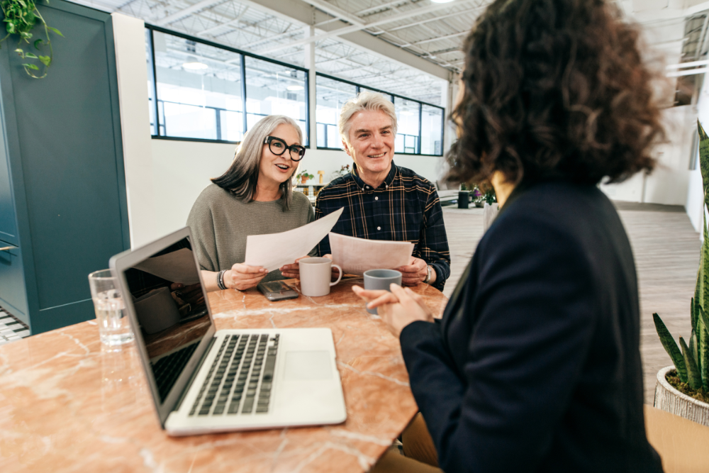a couple talking to the real estate agent