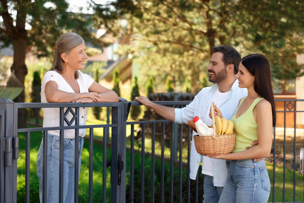 A happy couple sharing food to their new neighbor