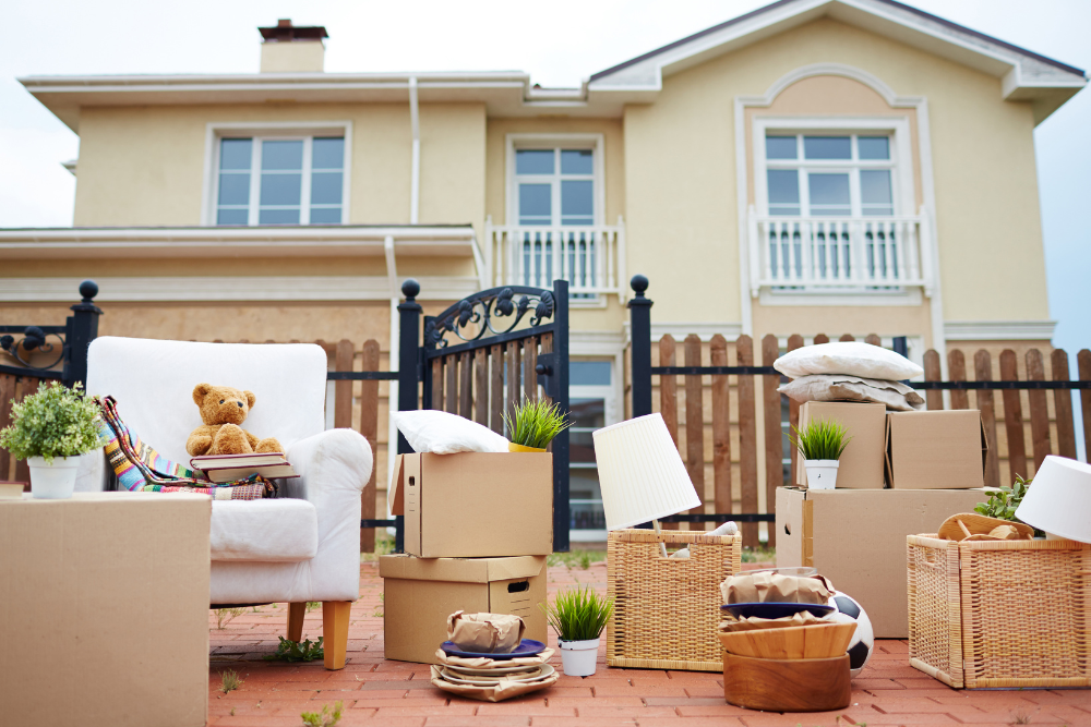 moving boxes and furniture outside a suburban home