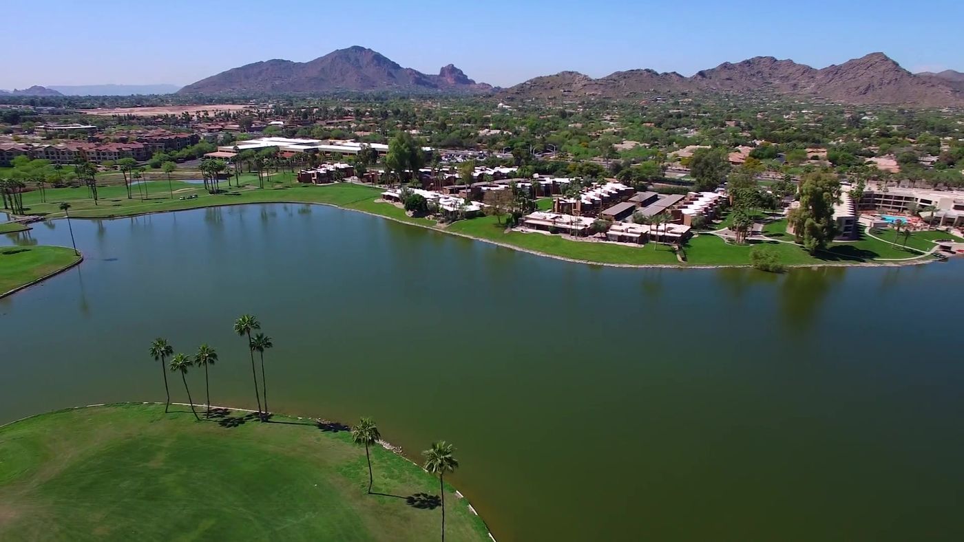 Aerial view of a lake community in central Scottsdale with mountains beyond