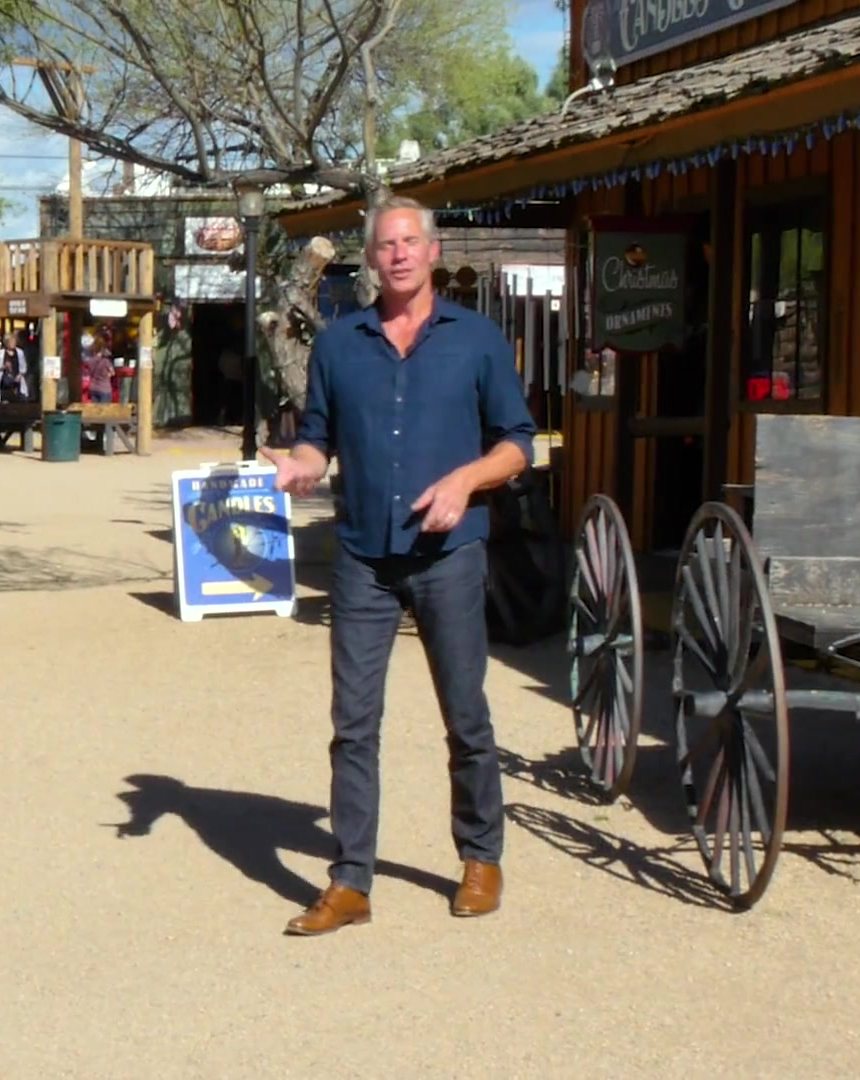 Mark Thomas presenting on a western street in Cave Creek
