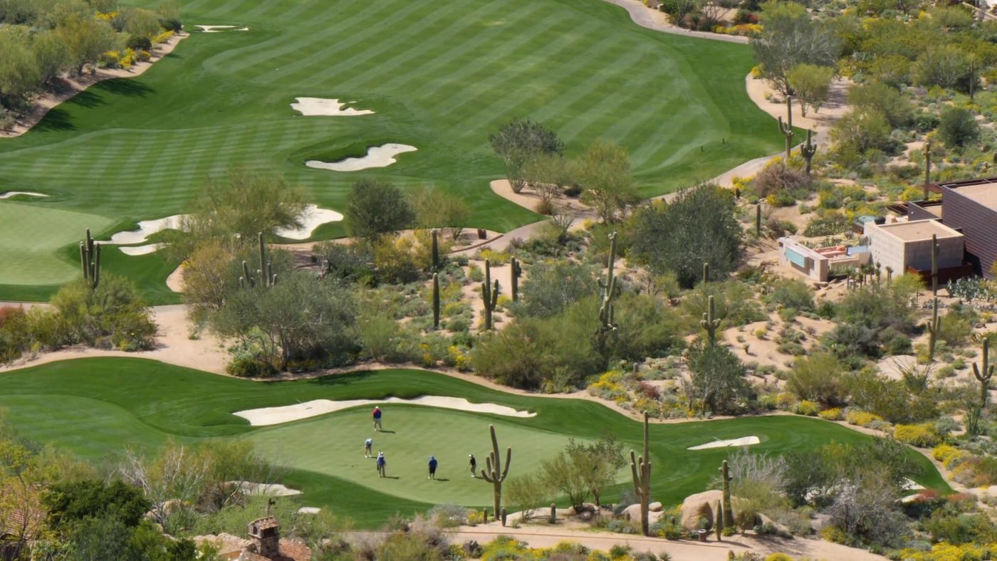 Aerial view of a North Scottsdale golf course fairway and green in the desert