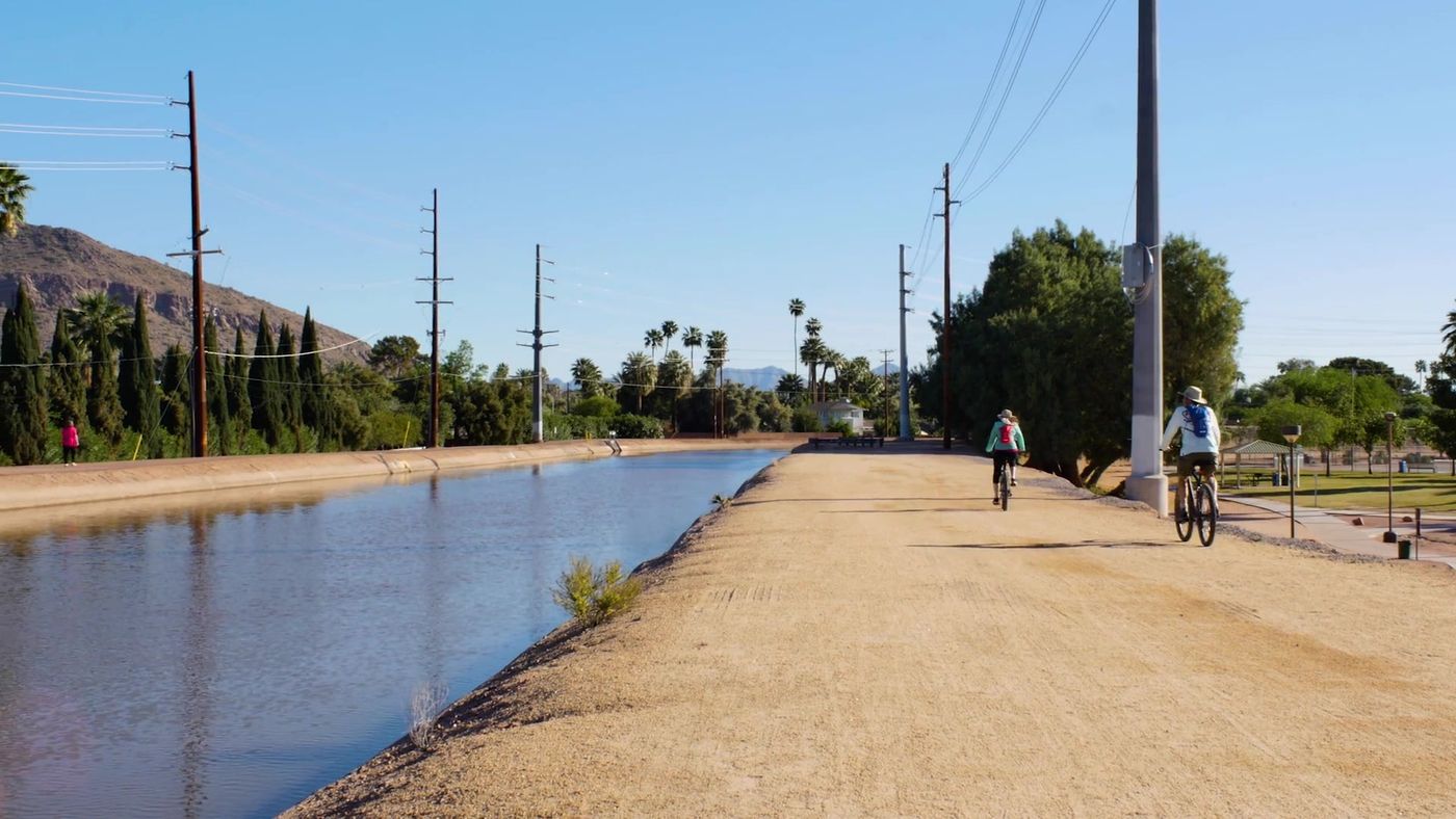 Walking and biking path along the Arizona Canal in Arcadia with Camelback Mountain