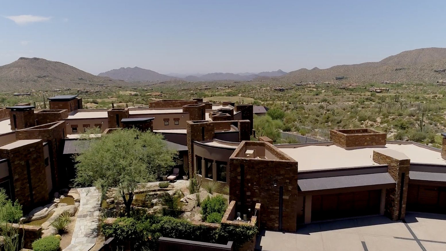 Aerial view of a contemporary stone estate in Desert Mountain with views across the desert