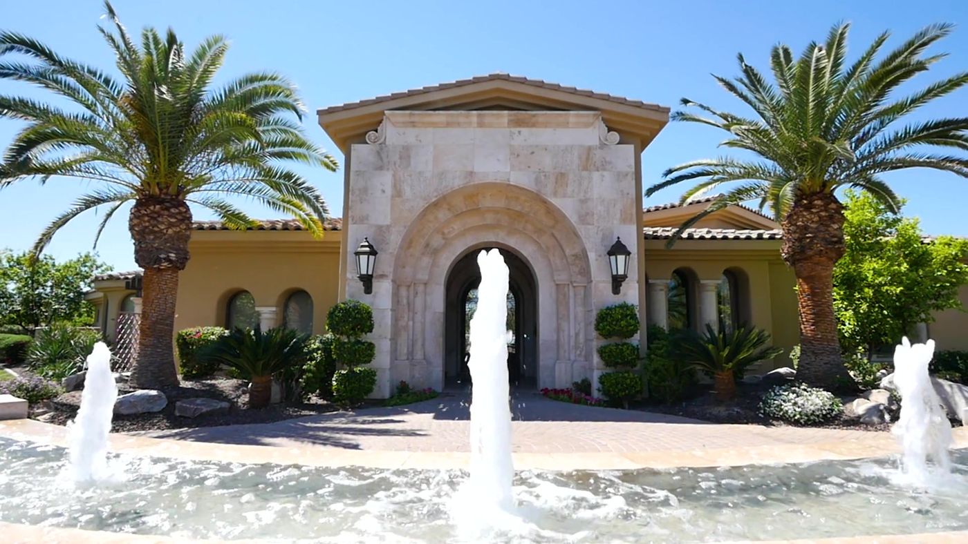 Mediterranean-style Scottsdale estate entry with fountains and palms