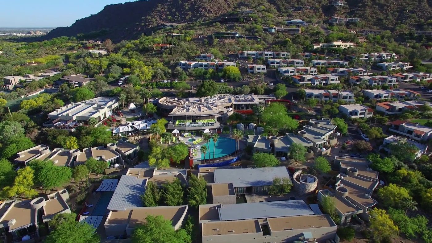 Aerial view of a Scottsdale resort with pools at the foot of Camelback Mountain