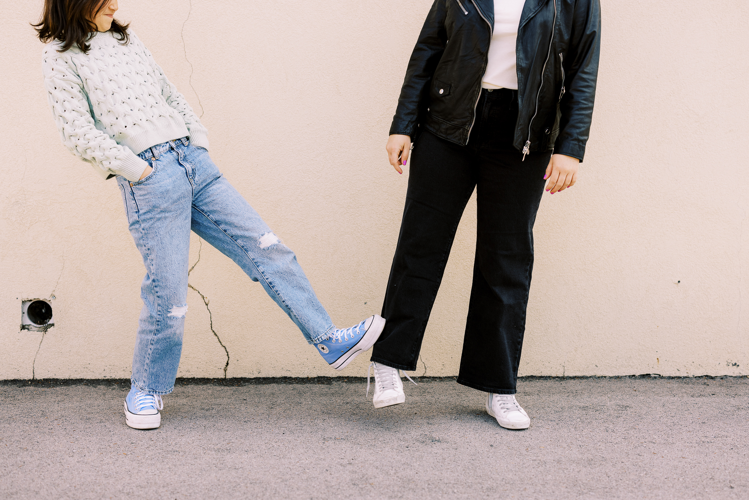 two friends stand in an urban environment