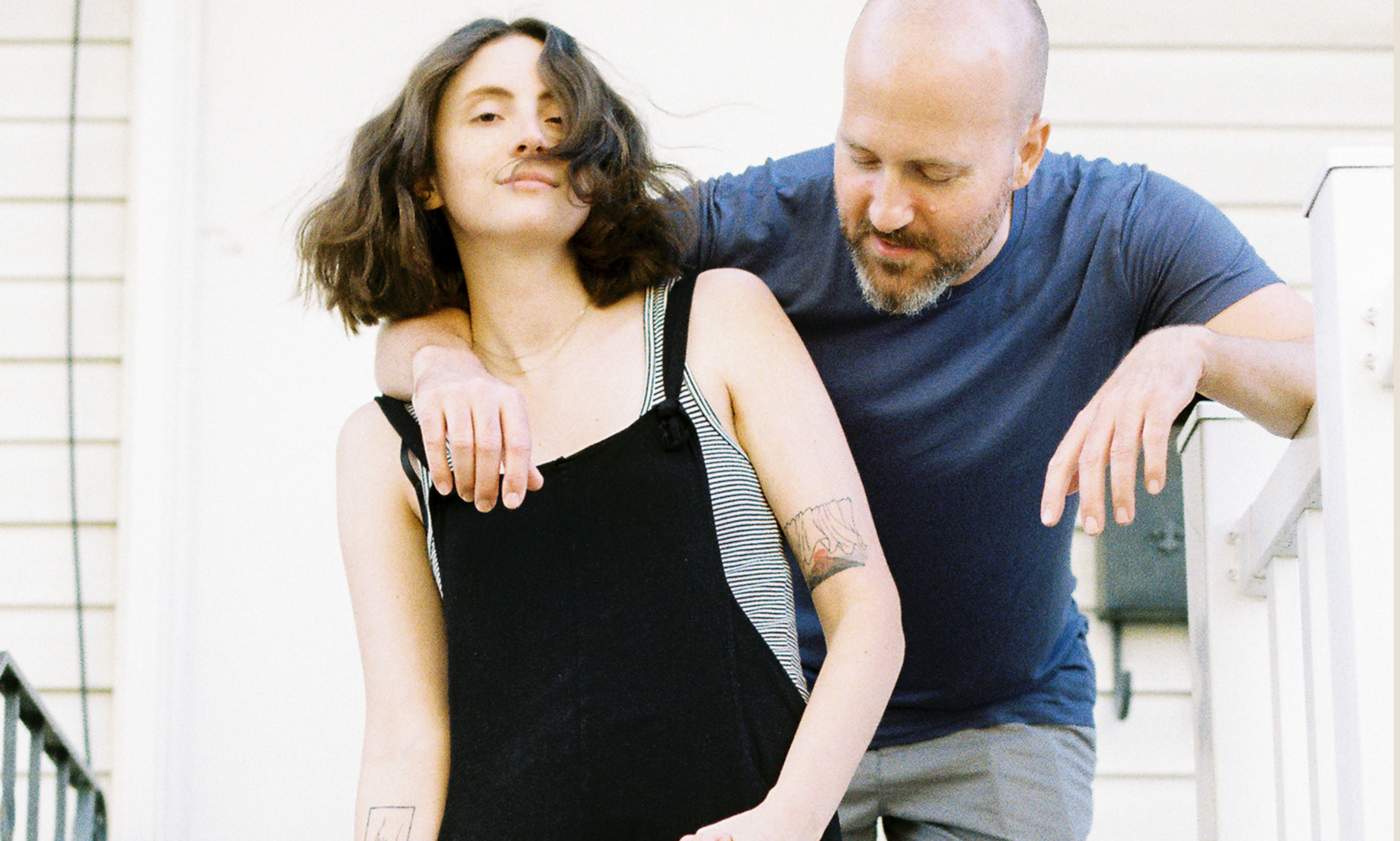 a family stands in front of their home