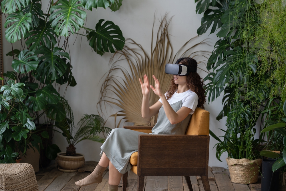 a woman sitting and using VR