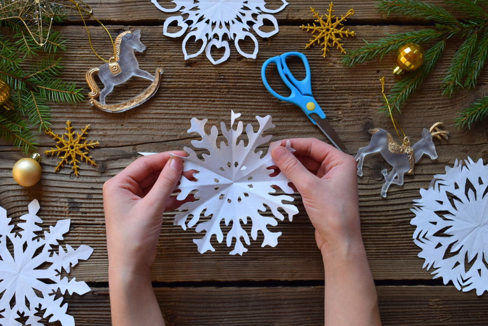 Holding paper made snowflakes